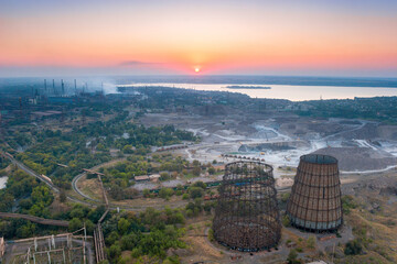 Aerial view of industrial area with metallurgical plants and cooling towers on sunset