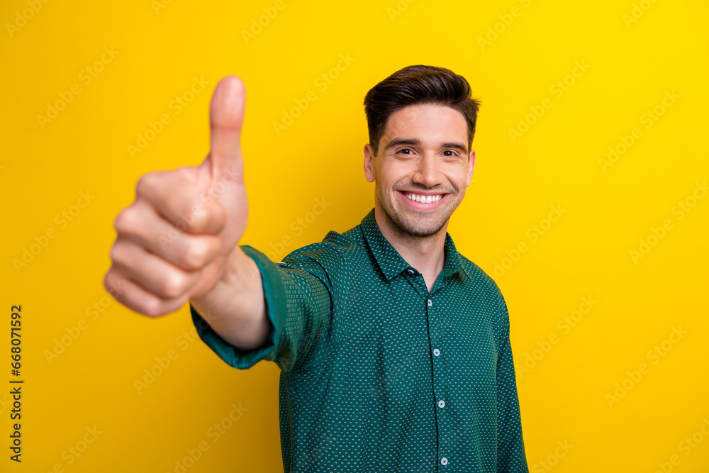 Sticker Photo of cheerful man wear stylish clothes hand demonstrate thumb up cool feedback nice offer isolated on yellow color background