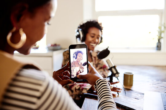 Woman making a video of a podcast