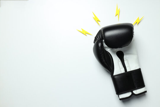 Black boxing gloves with zippers on a light background