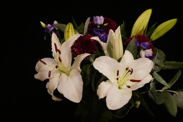 Decorative white and purple floral arrangement in a vase