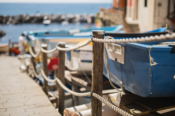 Fototapeta na wymiar Fishing wooden boat in the sea off the coast of a cozy village in the Mediterranean Sea