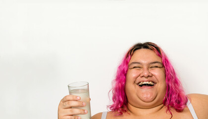 Woman laughing holding glass of water laughing