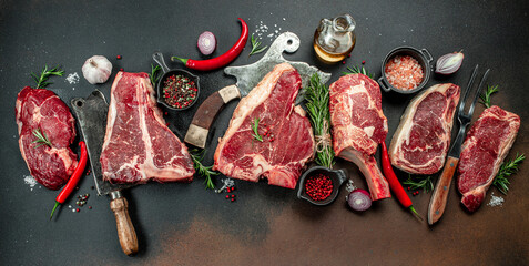 Black angus prime meat set for grilling with fresh herbs, spices. Long banner format. top view