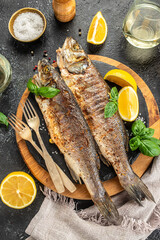 Delicious grilled fish seabass on a dark background. vertical image. top view. place for text