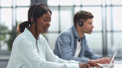 operators woman and man agent with headsets working in a call center - obrazy, fototapety, plakaty