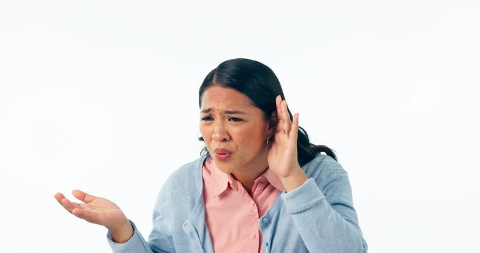 Face, deaf and woman in studio with hand on ear for hearing loss, what or communication fail on white background. Whisper, portrait and frustrated Asian lady model with speak up, emoji or questions
