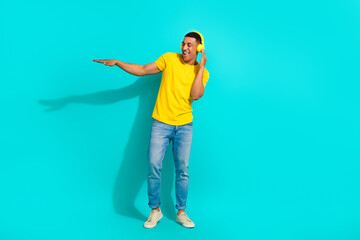 Full length portrait of positive excited person arm touch headphones dj playlist isolated on turquoise color background