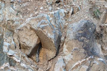 Rock structure, background. Natural rock background. Cracks and natural shapes of rocks