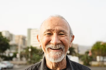 Tuinposter Happy senior man smiling in front of camera in the city - Elderly people lifestyle concept © Alessandro Biascioli