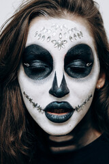 Girl with Halloween style makeup posing for the camera