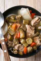 Traditional African okra soup on wooden table. Top view