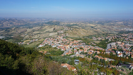 Fototapeta na wymiar Panorama of Republic of San Marino and Italy from Monte Titano, City of San Marino. City of San Marino is capital city of Republic of San Marino located on Italian peninsula, near Adriatic Sea.