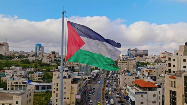 Vintage National Flag Waving Over Hebron Cityscape In Southern West Bank, Palestine. Aerial Shot