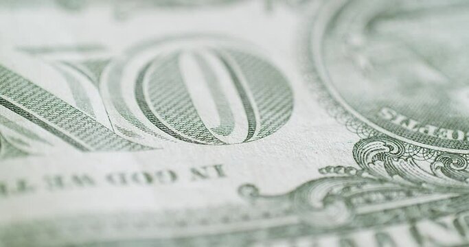 In a circular motion, a close-up of a one dollar bill bank note of the United States of America.