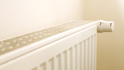 Central heating system. White metal heating iron household radiator inside room. Budget in crisis concept. House in winter