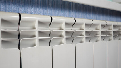 Central heating system. White metal heating iron household radiator inside room. Budget in crisis concept. House in winter