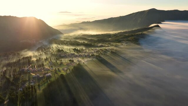 Aerial view of beautiful view village in the morning, sea of mist near Mount Bromo. Located in Bromo, Tengger, Semeru National Park, East Java, Indonesia.	