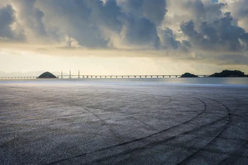Foto op Aluminium Asphalt road and coastline with sky clouds natural landscape at sunrise © ABCDstock