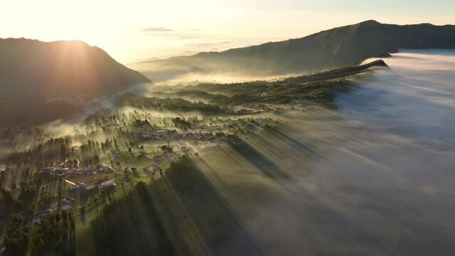 Aerial view of beautiful view village in the morning, sea of mist near Mount Bromo. Located in Bromo, Tengger, Semeru National Park, East Java, Indonesia.	