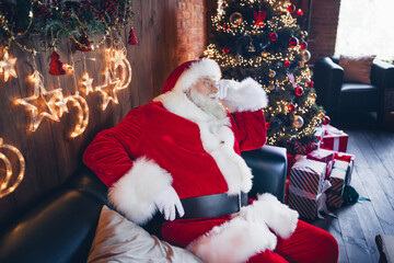 Photo of good mood dreamy santa claus dressed red eyewear relaxing comfortable couch indoors...