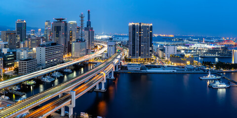 Kobe skyline from above with port and elevated road panorama at twilight in Japan