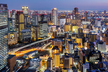 Osaka big city lights from above skyline with skyscraper at twilight in Japan