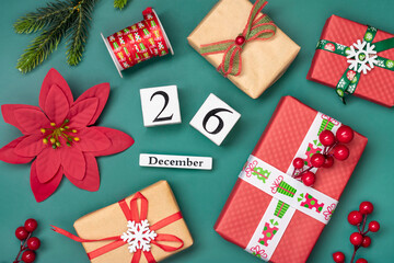 Gift boxes, wooden calendar with date December 26 on green background Boxing Day occurs annually on December 26 (day after Christmas). In 2023, Boxing Day falls on Tuesday, December 26 Xmas day - 668129530