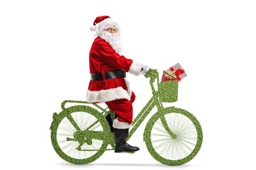 Full length profile shot of Santa Claus riding a green bicycle