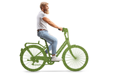 Full length profile shot of a bearded guy riding a green bicycle