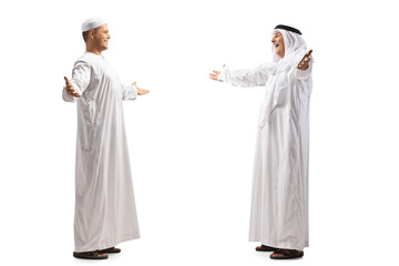 Young and mature muslim man in ethnic clothes greeting each other