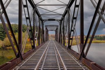 Double span riveted railway truss bridge built in 1893 crossing the Mississippi river in autumn in Galetta, Ontario, Canada - 668134927