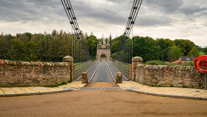 Union Chain Bridge entrance from England.  The Union Chain Bridge is a suspension road bridge that spans the River Tweed between England and Scotland located four miles upstream of Berwick Upon Tweed