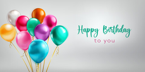 Festive birthday illustration with a bunch of colored helium balloons and inscription Happy Birthday to you on white background