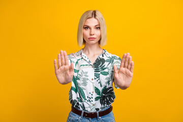 Photo of serious confident lady wear print shirt showing arms palms stop isolated yellow color...