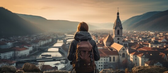 casual solo traveller female woman standing on the hill look over aerial topview of old famous...