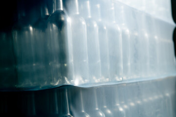Close-up shot of empty glass bottles standing in a row prepared for filling with wine at winery