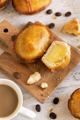 Pasticciotto leccese pastry filled with egg custard cream on a wooden board top view