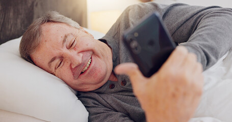 Senior man, happy and reading with phone in bed or streaming funny, comedy or meme on social media....