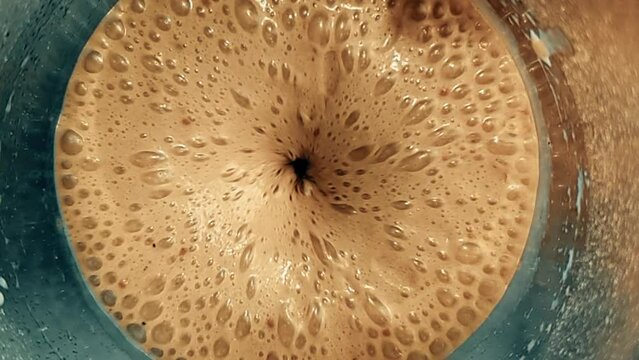 top of view of super slow motion shot of fresh cream brown coffe vortex, nutrition and health