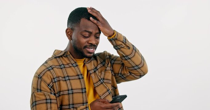 Student, man and phone with news, stress or confused for college results or mistake in studio. Face of african person on mobile with headache for university fail or loan rejection on white background