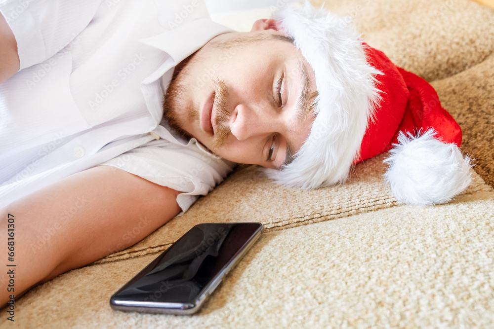 Canvas Prints young man sleep in santa hat