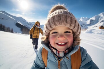 Fototapeta na wymiar a happy cheerful child in warm winter clothes taking a selfie on a ski vacation on winter christmas holidays on a snowy mountain riding a snowboard, having much fun in the snowy terrain
