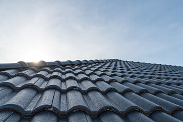 Close up of brown clay roof tiles. Red old dirty roof. Old roof tiles. Construction equipment build a house.