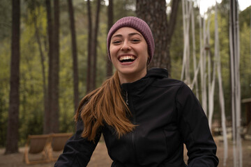 Outside a Glamping , The smiling girl holds a cup of coffee outdoors during the fall.
