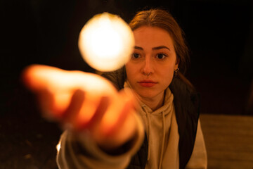 Girl touching round light bulb