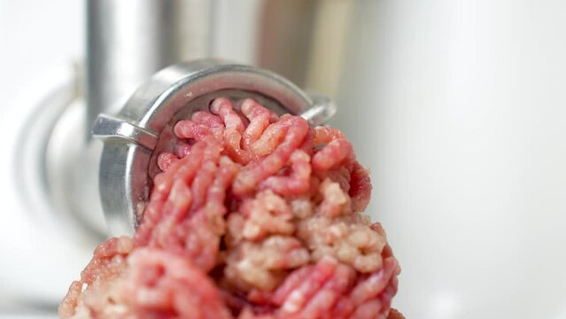 Beef mince in a mincing machine, close up.