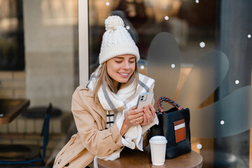 stylish woman walking in winter street