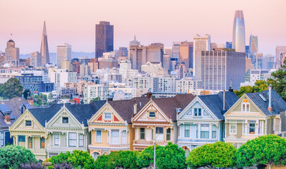 Painted Ladies Victorian houses in Alamo Square and a view of the San Francisco skyline and...