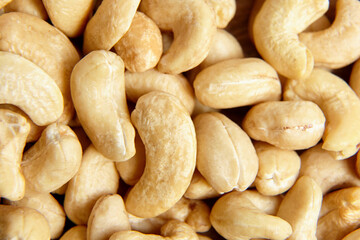 Obraz premium Cashew nut heap food texture background, macro shot. Cashews, a guilt-free treat, top view